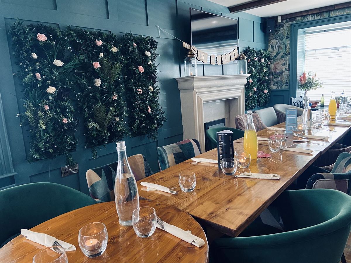 The private dining room at The Tailor's House, Ballygawley, styled with a floral wall for a celebration